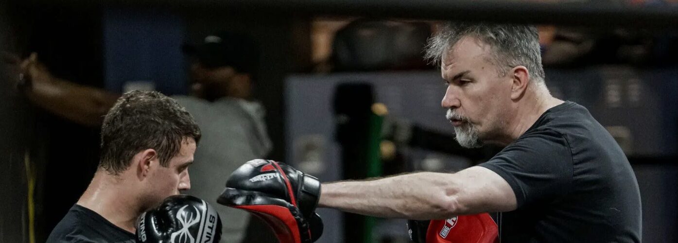 A man in black and red boxing gloves.